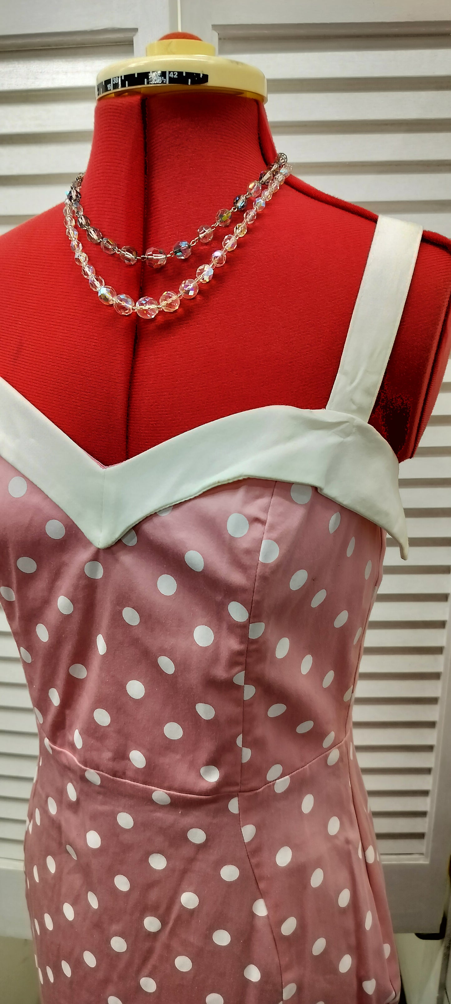 Deadly Dames label, us made, white polka dots over pink colour. Size- large.