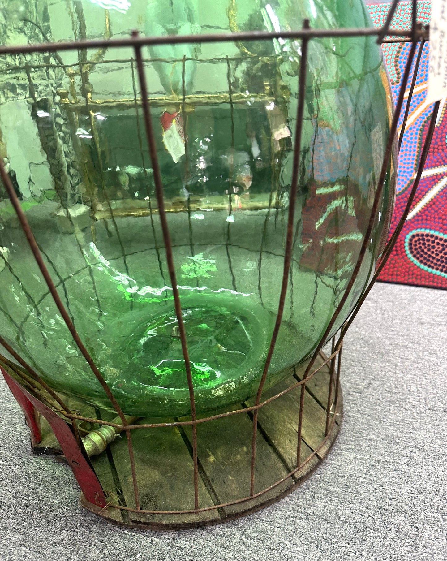 Green Demijohn glass in a metal bucket